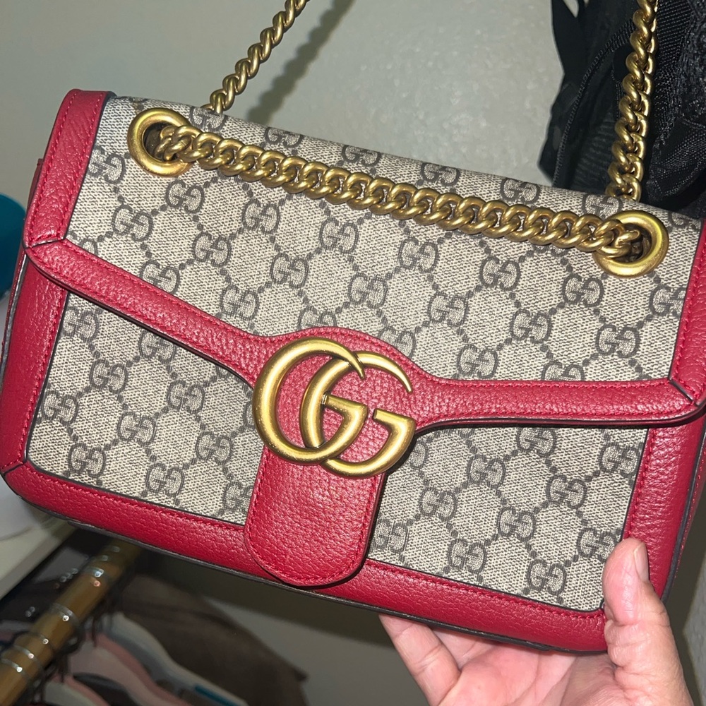 .beautiful red and canvas purse with adjustable straps.